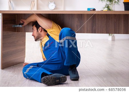 Young male carpenter working indoors 68578036