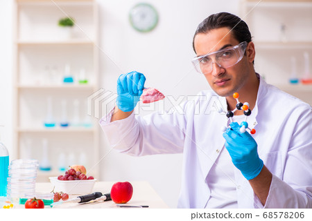 Young male nutrition expert testing food products in lab Young male nutrition expert testing food products in lab 68578206