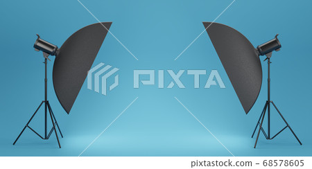 Photo studio lighting stands with flash and softbox on the blue background 68578605