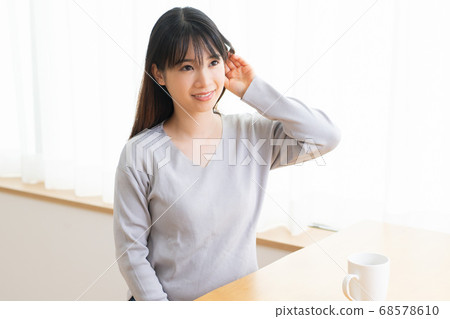 Young woman listening Young woman listening 68578610