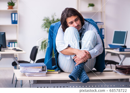 Male employee coming to work straight from bed Male employee coming to work straight from bed 68578722