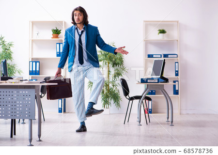 Male employee coming to work straight from bed Male employee coming to work straight from bed 68578736