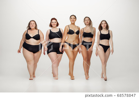 Portrait of beautiful young women with different shapes posing on white background 68578847