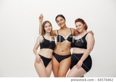 Portrait of beautiful young women with different shapes posing on pink background 68578862