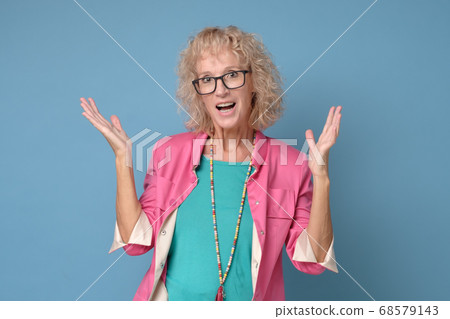 Old caucasian woman with surprised expression on her face Old caucasian woman with surprised expression on her face 68579143