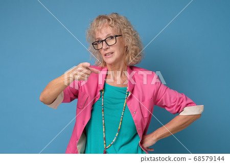 Woman frowning pointing index finger at camera, blaming you in all her problems. Woman frowning pointing index finger at camera, blaming you in all her problems. 68579144