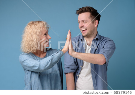 Mother and son giving high five to each other, clapping hands Mother and son giving high five to each other, clapping hands 68579146