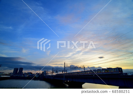Keisei Electric Railway crossing the Nakagawa Bridge at dusk 68580251