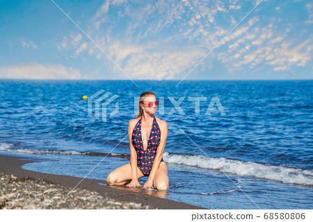 Young woman in the sea waves 68580806