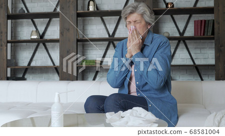 Elderly woman is having flu. Sick with a rhinitis woman dripping nose. Elderly woman is having flu. Sick with a rhinitis woman dripping nose. 68581004