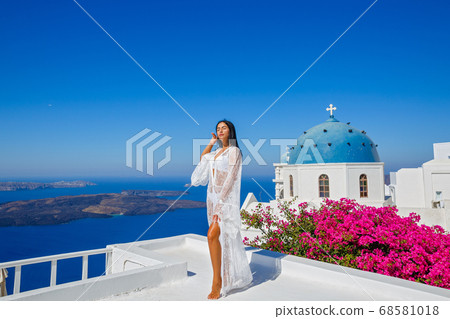 Beautiful woman in a white transparent dress Beautiful woman in a white transparent dress 68581018