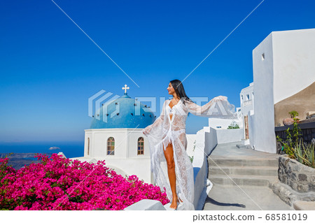 Beautiful woman in a white transparent dress Beautiful woman in a white transparent dress 68581019