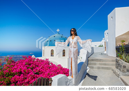 Beautiful woman in a white transparent dress Beautiful woman in a white transparent dress 68581020