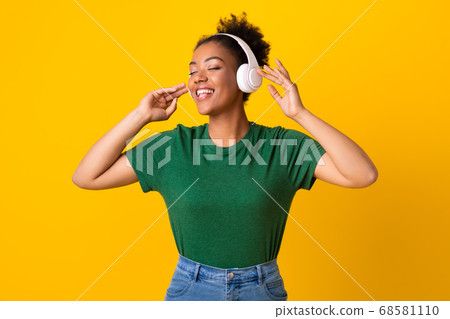 Portrait of joyful black girl enjoying music at studio Portrait of joyful black girl enjoying music at studio 68581110