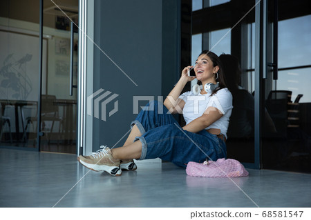 Young woman waiting for departure in airport, traveler with small baggage, influencer's lifestyle 68581547