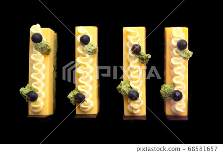 Orange mousse and pistachio sponge cake slices Orange mousse and pistachio sponge cake slices 68581657
