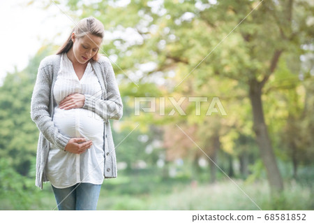 Expecting woman in nature Expecting woman in nature 68581852