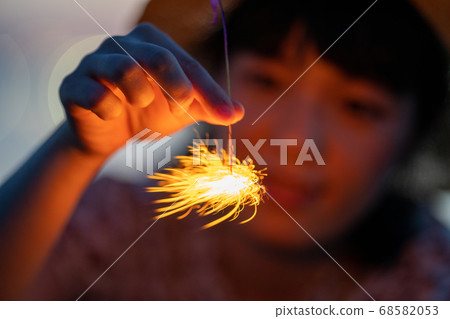 Woman enjoying a sparkler 68582053