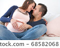 pregnant couple with heart shape 68582068