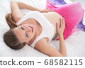 Smiling pregnant woman on her bed 68582115