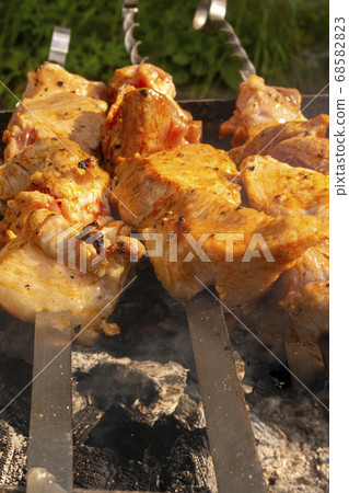 Juicy, fragrant kebab- roasted on fire over the grill Juicy, fragrant kebab- roasted on fire over the grill 68582823
