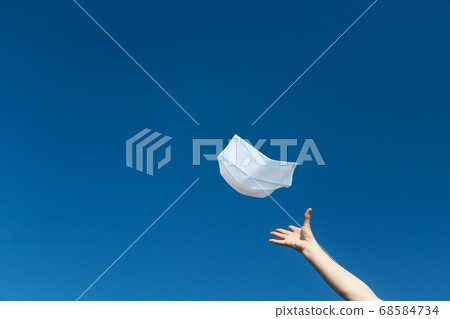 Female hand is throwing a protective face mask Female hand is throwing a protective face mask 68584734