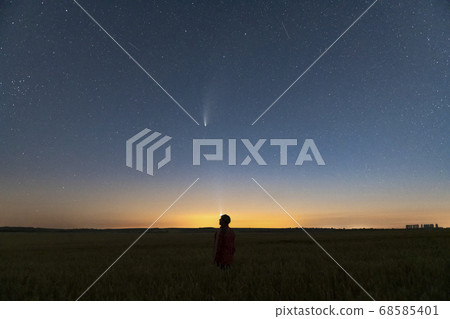 Silhouette of a man standing at night in a field outside the city Silhouette of a man standing at night in a field outside the city 68585401
