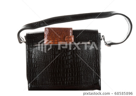 Brown wallet in the pocket of a man's black bag. Brown wallet in the pocket of a man's black bag. 68585896