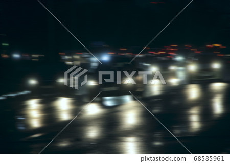 Automobiles with headlights and lights on in the Automobiles with headlights and lights on in the 68585961