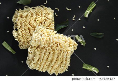Quick cooking noodle is one on a black background Quick cooking noodle is one on a black background 68586487