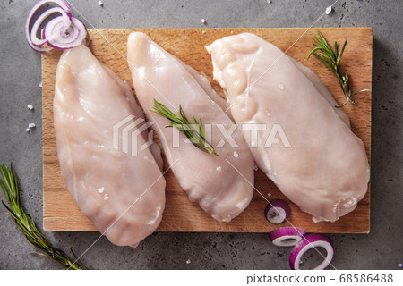 chicken fillet with rosemary and onion on a chicken fillet with rosemary and onion on a 68586488