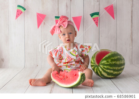 One year old baby girl eats watermelon. One year old baby girl eats watermelon. 68586901