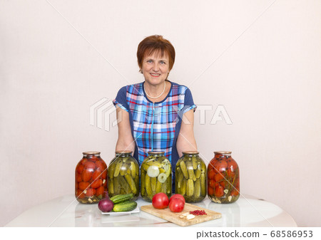 woman in blue plaid tunic in the kitchen next to woman in blue plaid tunic in the kitchen next to 68586953