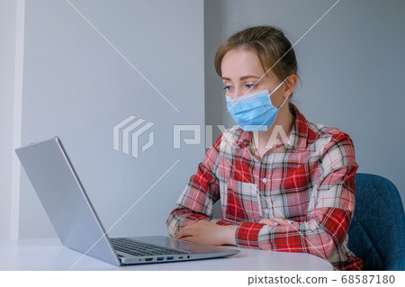 Woman looking at laptop, having video chat with friends at home Woman looking at laptop, having video chat with friends at home 68587180