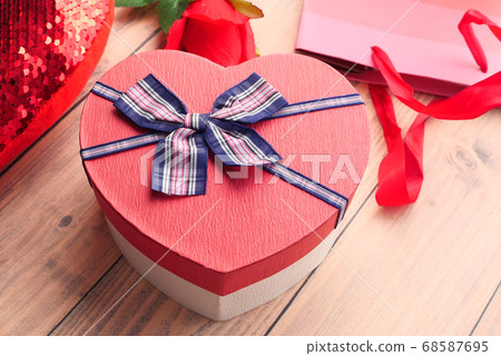 Close up of heart shape gift box on table. Close up of heart shape gift box on table. 68587695