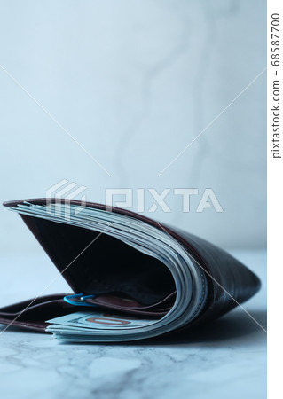 Close up of cash in wallet on table. Close up of cash in wallet on table. 68587700