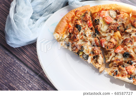 Slice of cheese pizza on a plate on wooden table. Slice of cheese pizza on a plate on wooden table. 68587727