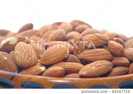 Close up of almond nut isolated on white Close up of almond nut isolated on white 68587728