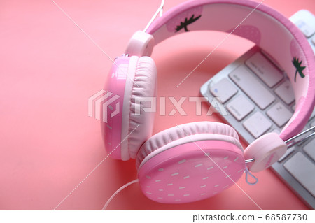 Top view of headphone on keyboard on pink . Top view of headphone on keyboard on pink . 68587730