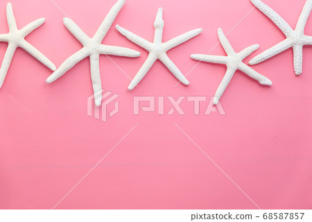 white starfishes on pink background top down. white starfishes on pink background top down. 68587857