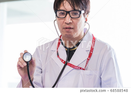 Doctor examining with a stethoscope Doctor examining with a stethoscope 68588548