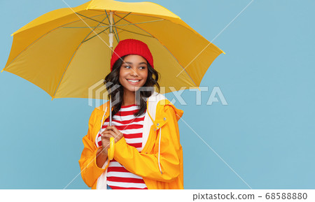 Happy ethnic female under bright umbrella. 68588880