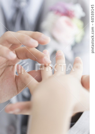 Bride and groom exchange rings 68589145