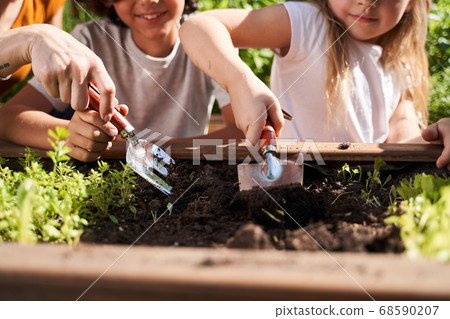 Little girl and boy preparing soil for plants 68590207