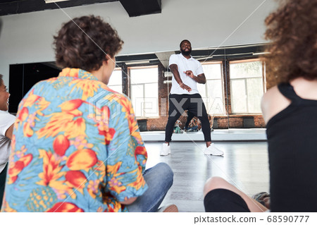 Young sporty man teaching dancing in studio 68590777