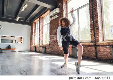 Graceful young woman dancing in sport studio 68590811