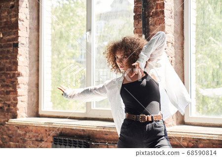 Beautiful young female dancing alone with passion 68590814