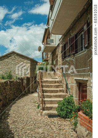 Facade of a stone house with staircase 68591018