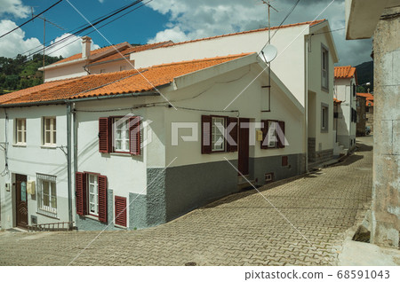 Alley and old houses with plaster wall 68591043