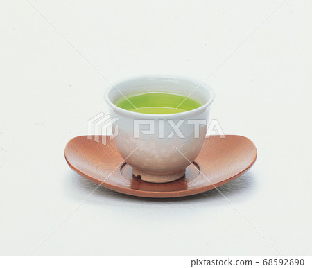 A teacup with green tea A teacup with green tea 68592890